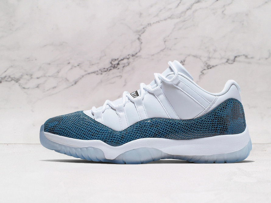 Side profile of Air Jordan 11 Retro 'Snake Navy' with White leather upper and Navy snakeskin overlay on a clean background