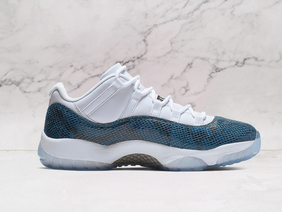 Close-up of Air Jordan 11 Retro 'Snake Navy' heel, highlighting Black Jumpman logo and translucent Navy-tinted outsole.