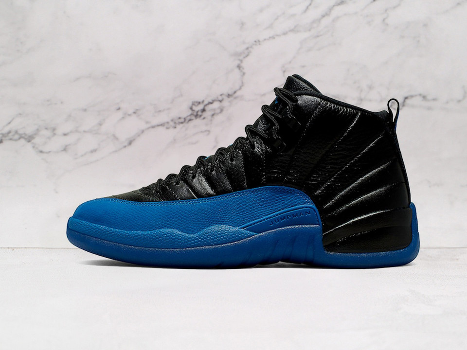 Side of Air Jordan 12 Retro Black Game Royal with blue accents. Side of Air Jordan 12 Retro Black Game Royal with blue accents.