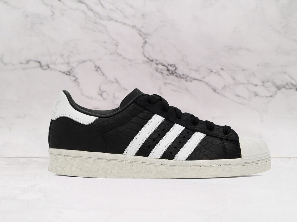Adidas Superstar 82 Core Black Alumina Cream sneaker with shell toe.