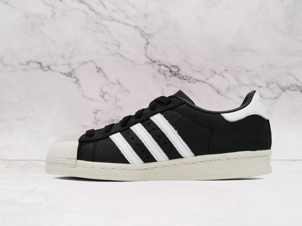 Adidas Superstar 82 Core Black Alumina Cream medial view with cream accents