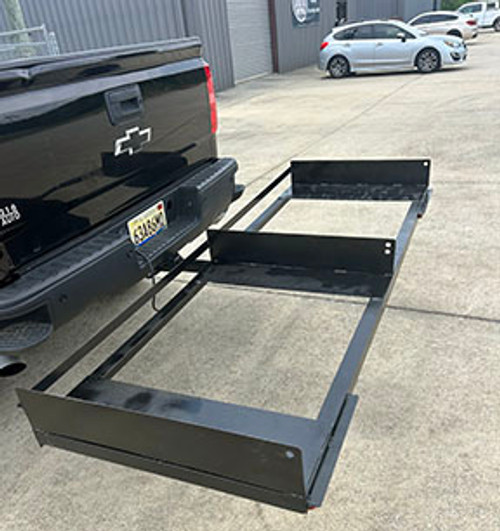 Side view of the hitch-mounted 2-unit portable restroom hauler with two restrooms loaded – solid steel frame and professional design.