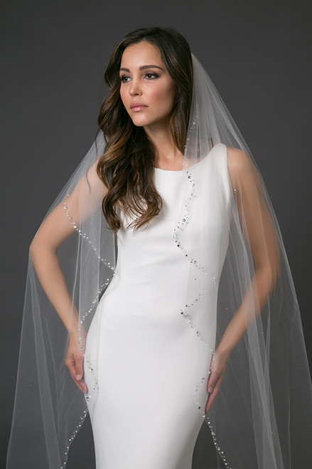 With softly cascading sides and a full train, Prima features a classic shape to finish a gowns silhouette. The border is heavily encrusted with a variety of Swarovski crystal and pearl sizes for an enticing finish.