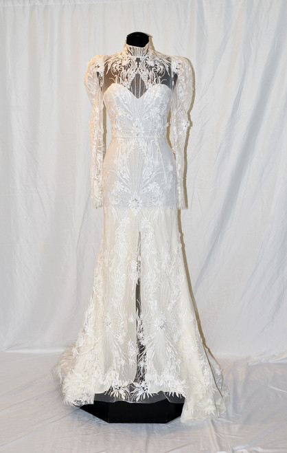 Illusion high neck, long sleeve sheath with retro shoulder detail and open back.