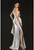 Three-dimensional sculptured bodice has a cascading flower and beads with oversized draped bow skirt.