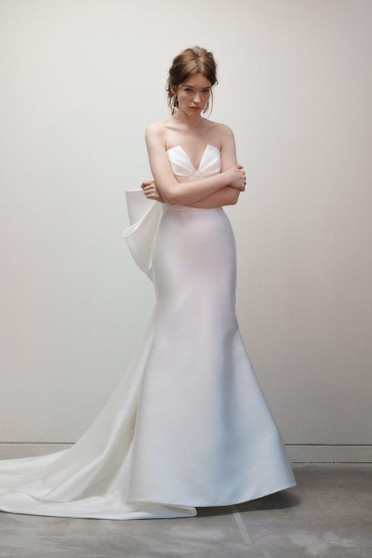 Draped V neck bodice with seamed midriff details and couture back bow.