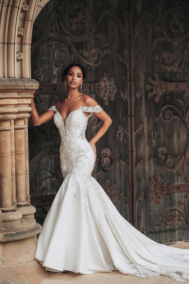Inspired by Jasmine's bold and adventurous spirit, this elegant gown features beautiful detailing with crystal embroidery and an off the shoulder neckline. The gown is highlighted by its striking illusion back with sparkling embroidery detail and elaborate cutaway lace train.