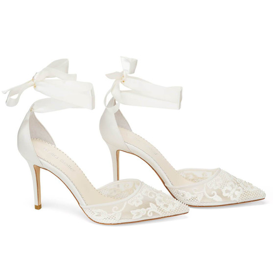 Silky ivory ribbons caress the leg, reminiscent of a traditional ballet slipper on these wedding heels with pearls. Delicately loop the ribbons around your ankle and knot the ends into a trim bow. Only the most discerning observer will spot the pearl beads incorporated into the floral lace design.
