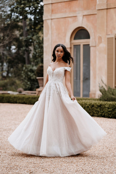 Dazzling beading covers the bodice and off-shoulder cap sleeves of this elegant ballgown.
