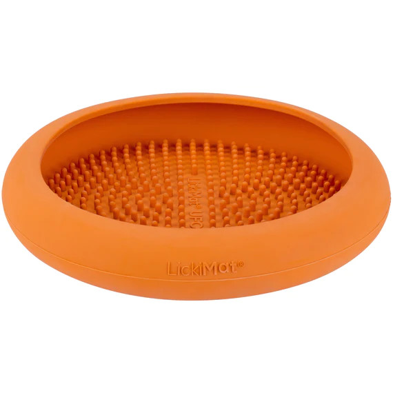 Interactive LickiMat UFO pet feeder in vibrant orange with textured surface for engaging pets.