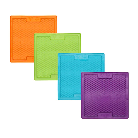 Colorful Lickimat Soother slow feeding mats for dogs in orange, green, blue, and purple.