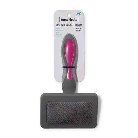 Bow + Bell Dog Slicker Brush Small features a cushioned handle and fine bristles for effective grooming.