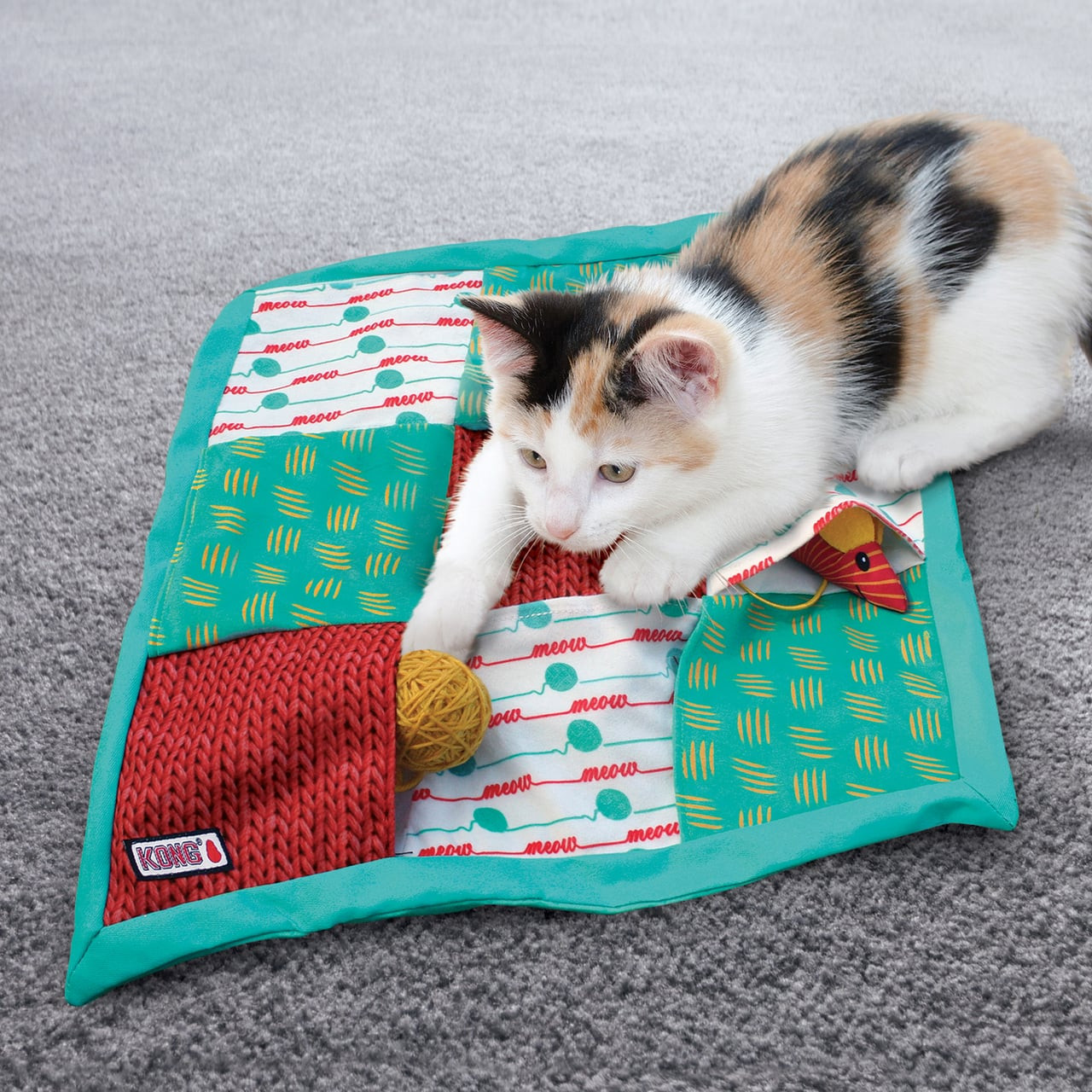KONG Puzzlement Pockets Cat Play Mat with colorful textures and hidden toys for engaging play.