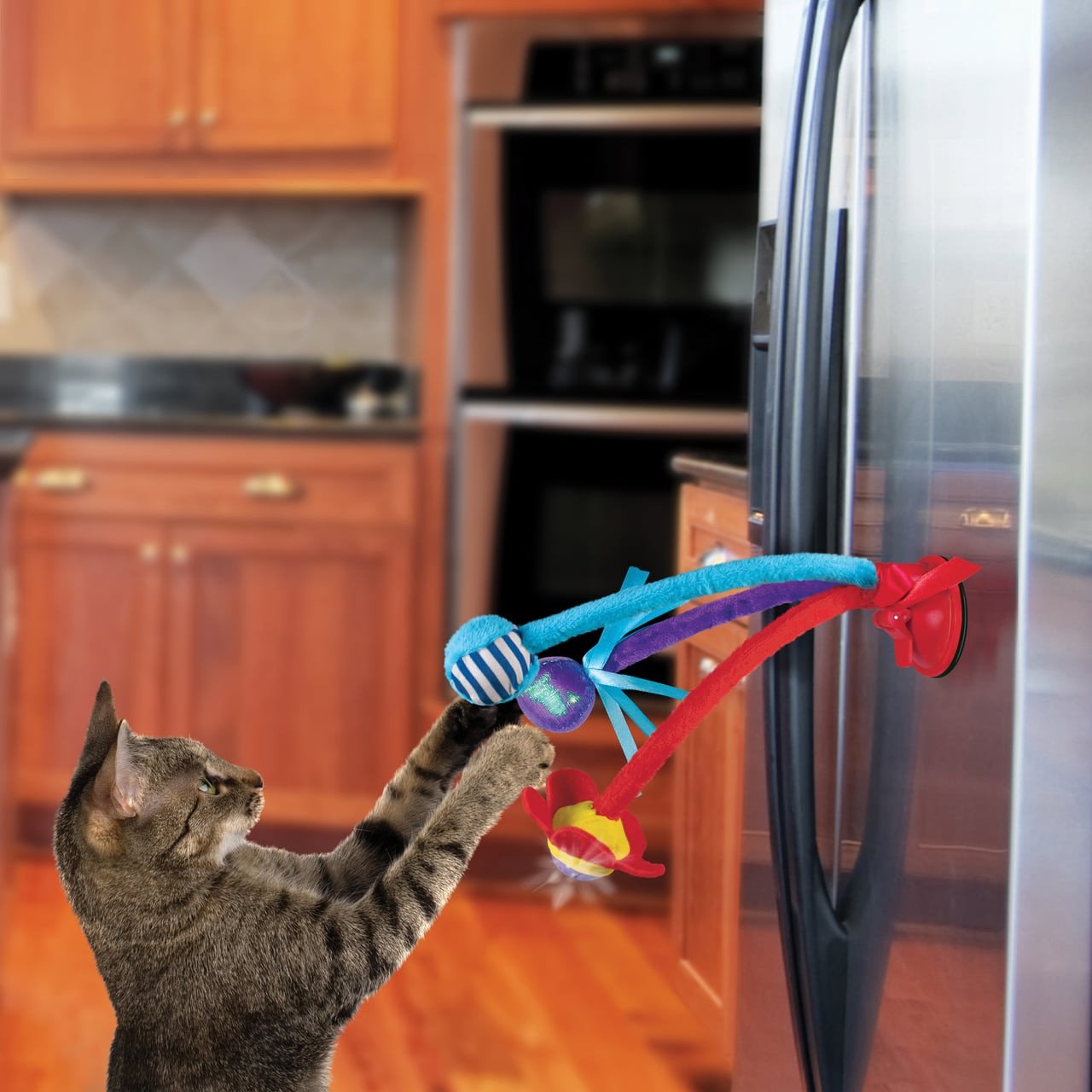 KONG Connects Bat n Swing Cat Toy with colorful attachments engaging a playful cat.