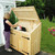 woman putting trash into Manchester Pine Wood Trash and Recycling Bin