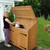 Woman Placing garbage bag into Manchester Cedar Wood Trash and Recycling Bin