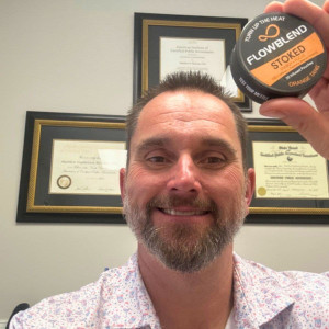 Customer at his office holding a STOKED Orange Tang energy pouch can
