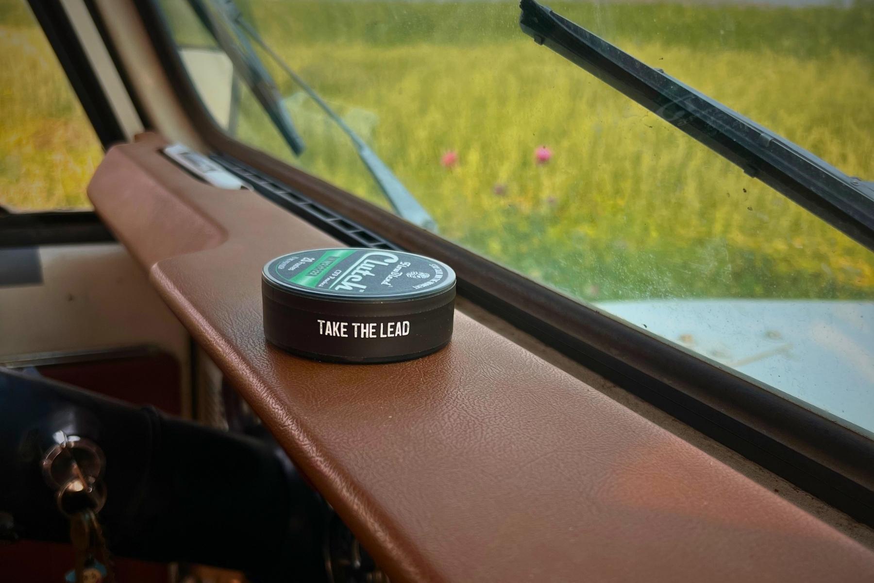 CLUTCH CBD pouches can on a truck tailgate at the end of the workday