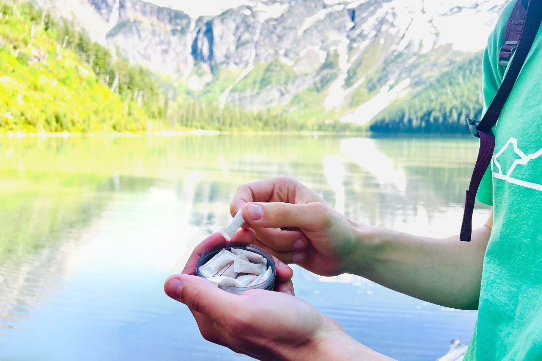 CLUTCH CBD pouches can on the trail with a mountain view, the pause before you go
