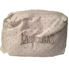 White Cosmetic Purse with shiny specks all over it and a large Silver embroidered Las Vegas on the front, white tassel pull zipper.