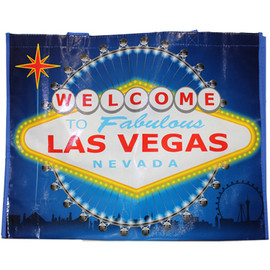 Blue background tote bag has a huge Yellow and Red colorful Welcome to Las Vegas Sign as the dominant focus on this item.