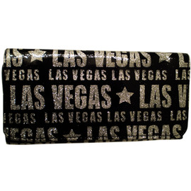 Black plastic wallet with Las Vegas in different size fonts in a silver glitter printed all over it.