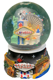 Acrylic base and a Glass Snowglobe. Base is Black with colorful icons. Inside the snowglobe has glitter snow and colorful 3D versions of the Las Vegas Casinos that you know and love.