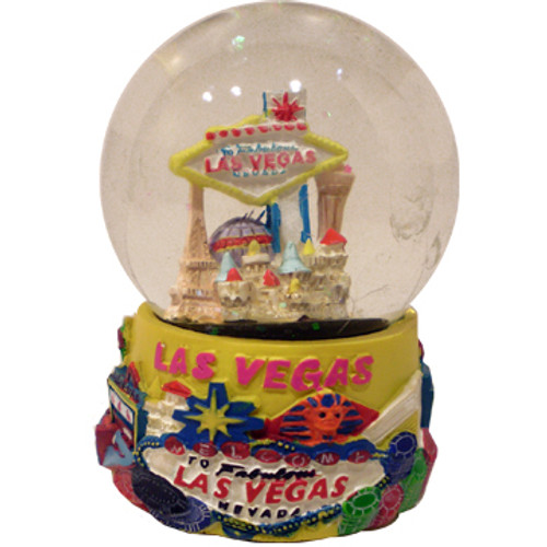 Acrylic base and a Glass Snowglobe. Base is yellow with colorful icons. Inside the snowglobe has glitter snow and colorful 3D versions of the Las Vegas Casinos and Welcome Sign that you know and love.