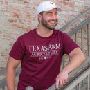 Maroon Texas A&M Agriculture short sleeve T-shirt featuring large white "Texas A&M Agriculture" lettering across the chest with "Est. 1876" printed below. Classic crew neck tee with a traditional collegiate design.
