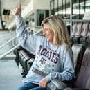 Gray Texas A&M crewneck sweatshirt featuring bold Aggies lettering, a football graphic with the A&M logo, and 12th Man design elements. Vintage-inspired sweatshirt celebrating Texas A&M football tradition.