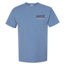 "AGGIE" printed in maroon ink centered above "outdoors" in script font tan ink on the left chest.