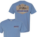 Light blue Texas A&M Outdoors T-shirt featuring a small Aggie Outdoors logo on the front and a vintage hunting scene with a retriever and Texas A&M graphic on the back.