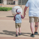 Texas A&M youth baseball trucker hat featuring a white front with raised maroon baseball stitching, maroon bill, maroon mesh back, side Texas A&M logo, and "Aggie Baseball" embroidered above the snapback closure.