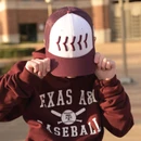 Texas A&M youth baseball trucker hat featuring a white front with raised maroon baseball stitching, maroon bill, maroon mesh back, side Texas A&M logo, and "Aggie Baseball" embroidered above the snapback closure.