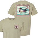 Khaki Texas A&M Comfort Wash T-shirt featuring a small vintage stamp-style A&M logo on the front and a large wood duck postage stamp graphic on the back with Texas A&M University and Established 1876 details.