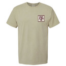 Khaki Texas A&M Comfort Wash T-shirt featuring a small vintage stamp-style A&M logo on the front and a large wood duck postage stamp graphic on the back with Texas A&M University and Established 1876 details.
