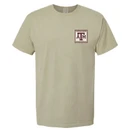 Khaki Texas A&M Comfort Wash T-shirt featuring a small vintage stamp-style A&M logo on the front and a large wood duck postage stamp graphic on the back with Texas A&M University and Established 1876 details.