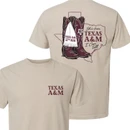 Natural cream Texas A&M T-shirt featuring maroon front lettering and a western back graphic with cowboy boots, Texas outline, 12th Man details, and “She’s from Texas A&M” text.