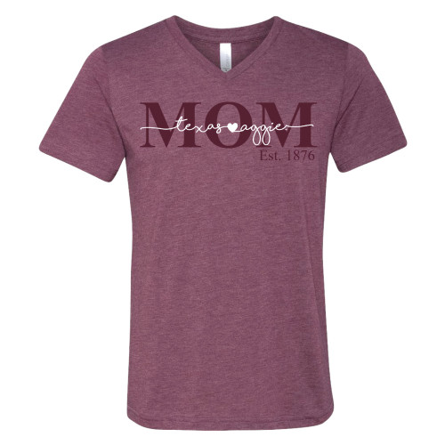 Heather maroon v-neck t-shirt saying "MOM" in maroon ink with a script "texas aggies" in white layered over it.