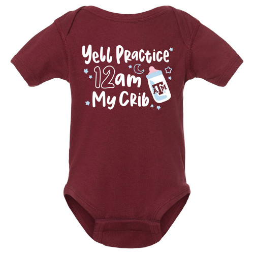 "YELL PRACTICE 12AM MY CRIB" printed in white beside a baby bottle and light blue stars on the front of the maroon short sleeve onesie.