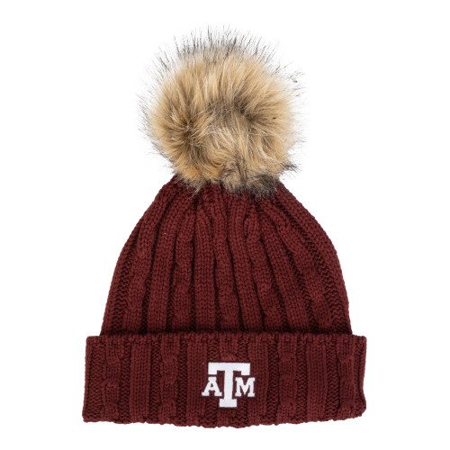 Maroon Texas A&M cable-knit beanie with a fold-over cuff, embroidered A&M logo patch, and faux fur pom on top.