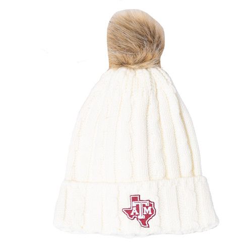 Ivory Texas A&M cable-knit beanie featuring a fold-over cuff, faux fur pom, and embroidered Texas-shaped A&M logo patch on the front. Soft winter hat designed for warmth, comfort, and stylish game day wear.