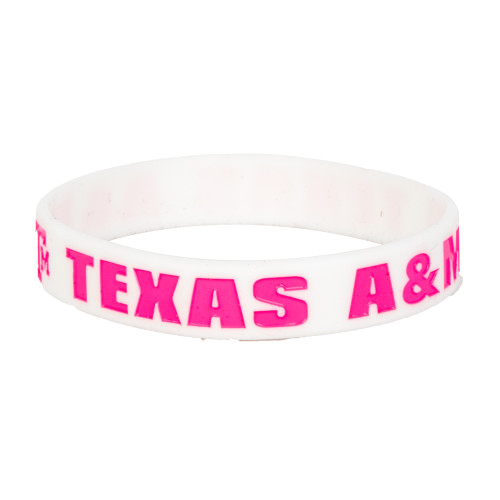 White Texas A&M silicone wristband featuring bright pink "Texas A&M" lettering. Comfortable rubber bracelet for game days, campus events, everyday wear, and showing Aggie spirit.