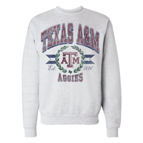 Heather gray Texas A&M crewneck sweatshirt featuring distressed "Texas A&M" lettering above a vintage banner with the Texas A&M logo, "Aggies," and "1876." Retro pullover for game days and everyday wear.