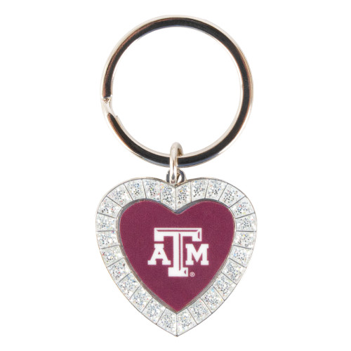 Texas A&M heart-shaped keychain featuring a maroon center with the white Texas A&M logo, sparkling crystal border, and silver-tone metal key ring. Stylish accessory for keys, bags, and backpacks.