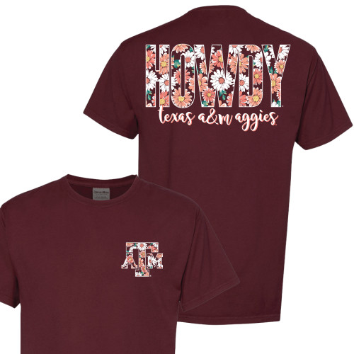 Maroon Texas A&M T-shirt featuring a small floral "Howdy" graphic on the front and a large floral "HOWDY" design with "texas a&m aggies" script across the back. Short sleeve tee for game days and everyday wear.