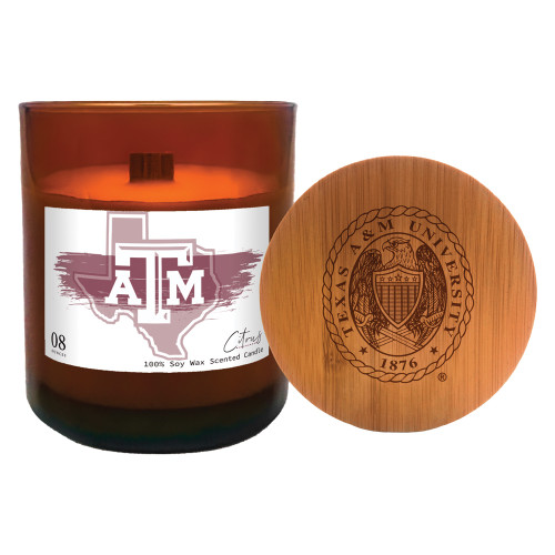 Texas A&M citrus candle in an amber glass jar featuring a Texas A&M label and an engraved wooden lid. Fresh scented candle for dorm rooms, offices, homes, and Aggie gift giving.