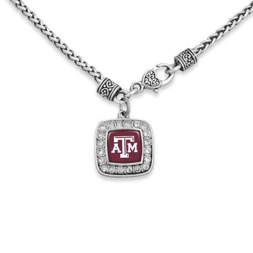 Texas A&M necklace featuring a silver-tone chain and a square pendant with sparkling stone accents surrounding a maroon Texas A&M logo centerpiece.