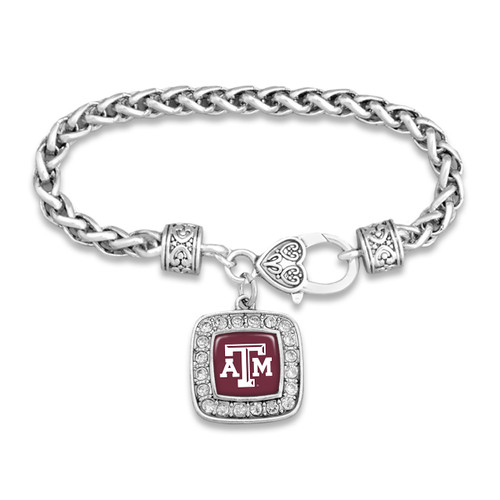 Texas A&M charm bracelet featuring a silver-tone chain with decorative accents and a square pendant displaying a maroon Texas A&M logo surrounded by sparkling stones.