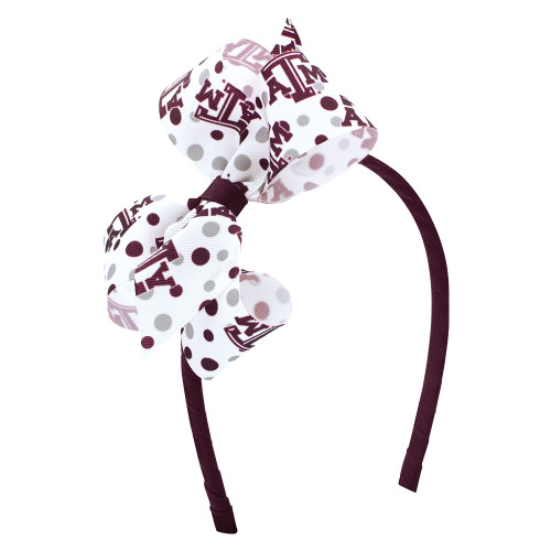 Texas A&M bow headband featuring a maroon headband and a large white bow with maroon polka dots and Texas A&M logos. Stylish accessory for game days and everyday wear.